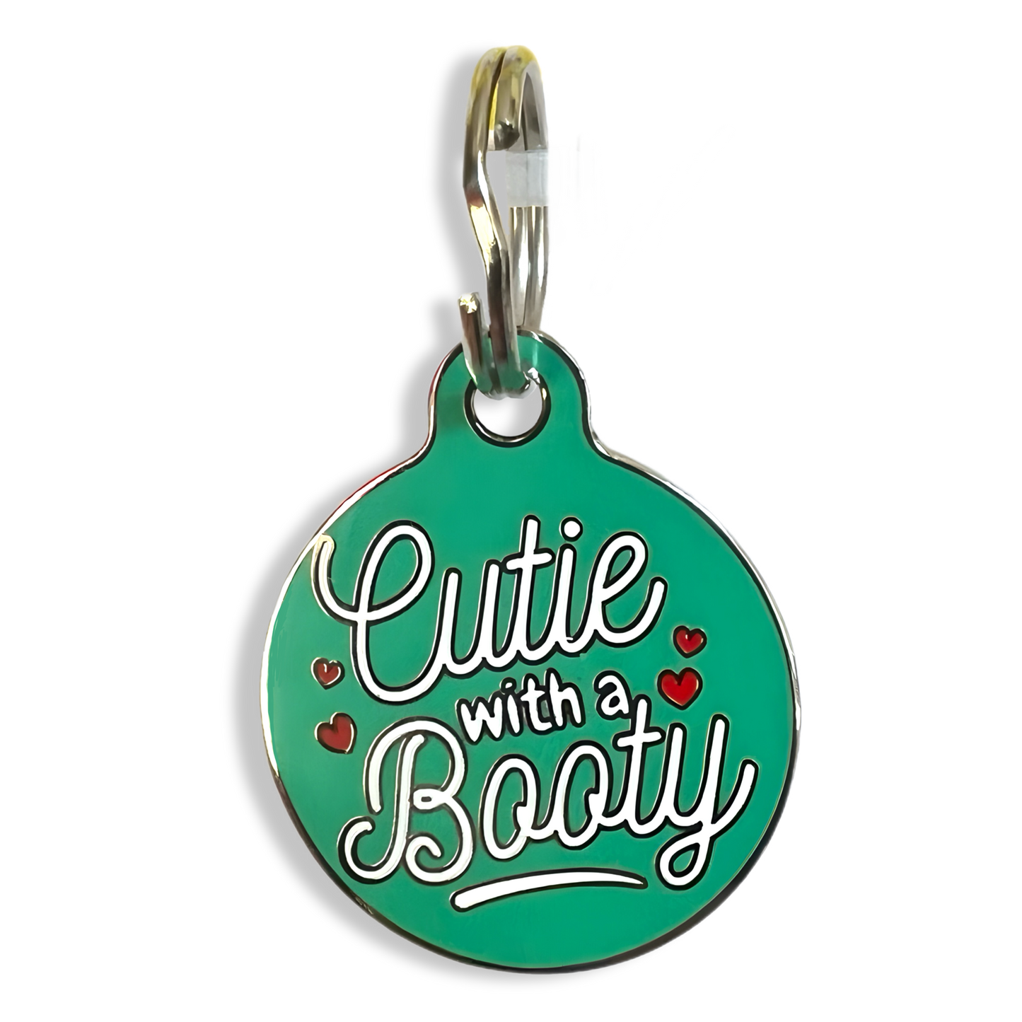 A humorous dog tag inscribed with "Cutie with a Booty," showcasing in a vibrant green tag.