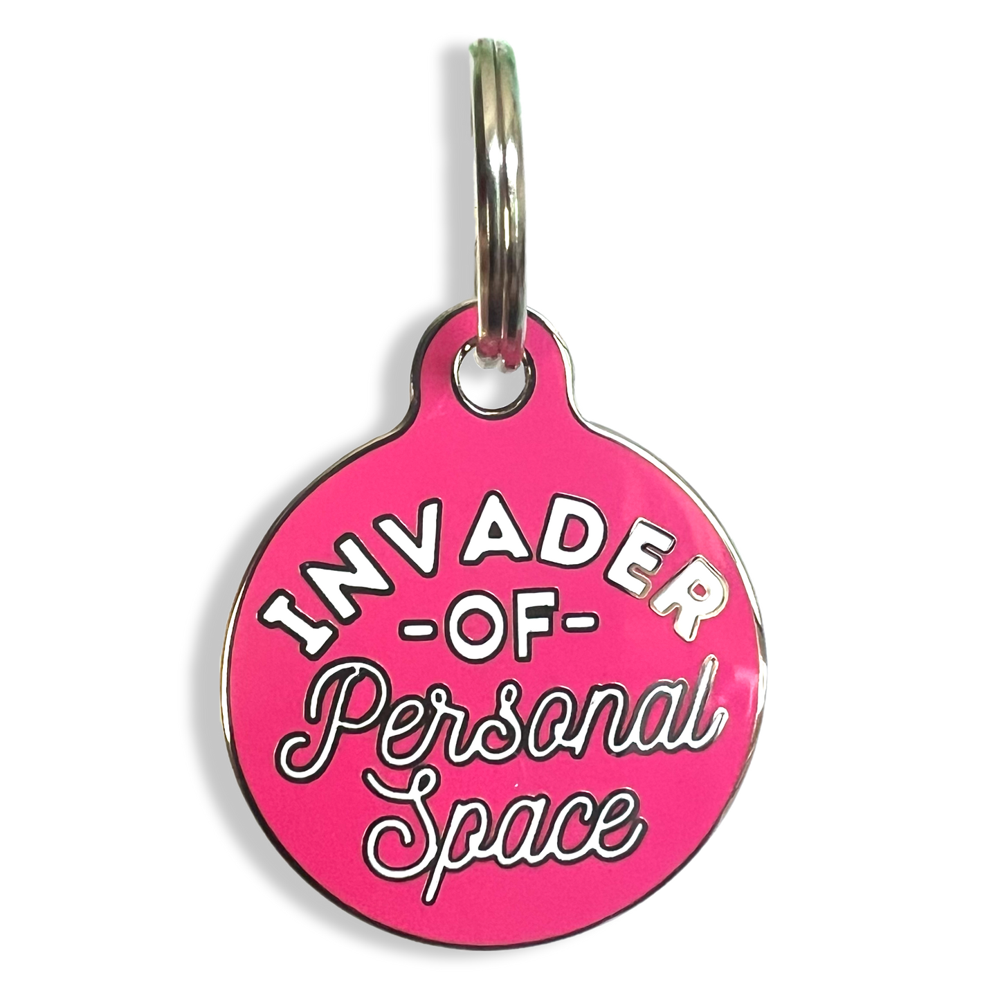 A humorous dog tag inscribed with "Invader of Personal Space," showcasing a lighthearted take on personal boundaries.