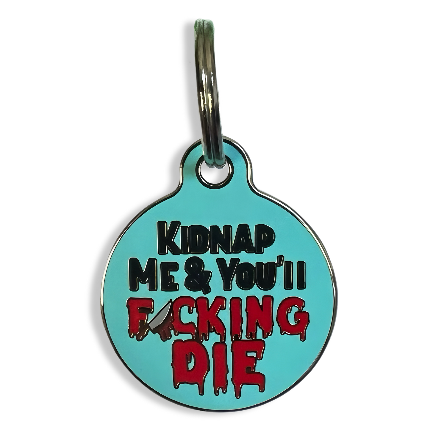 A dog tag displaying the provocative phrase "kidnap me and you're fucking die" in bold lettering.