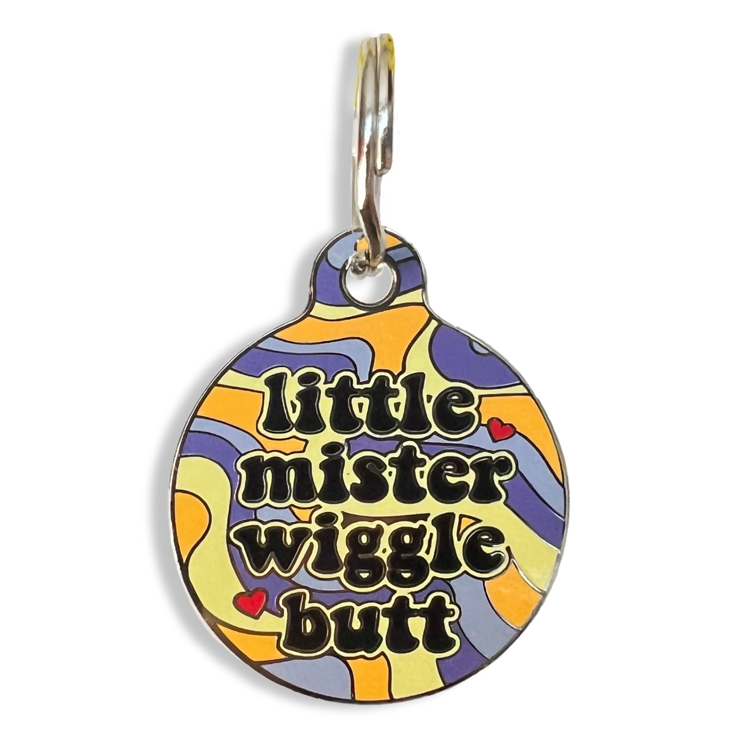 A detailed view of a dog tag featuring the inscription "little mister wiggle butt," highlighting its whimsical character.