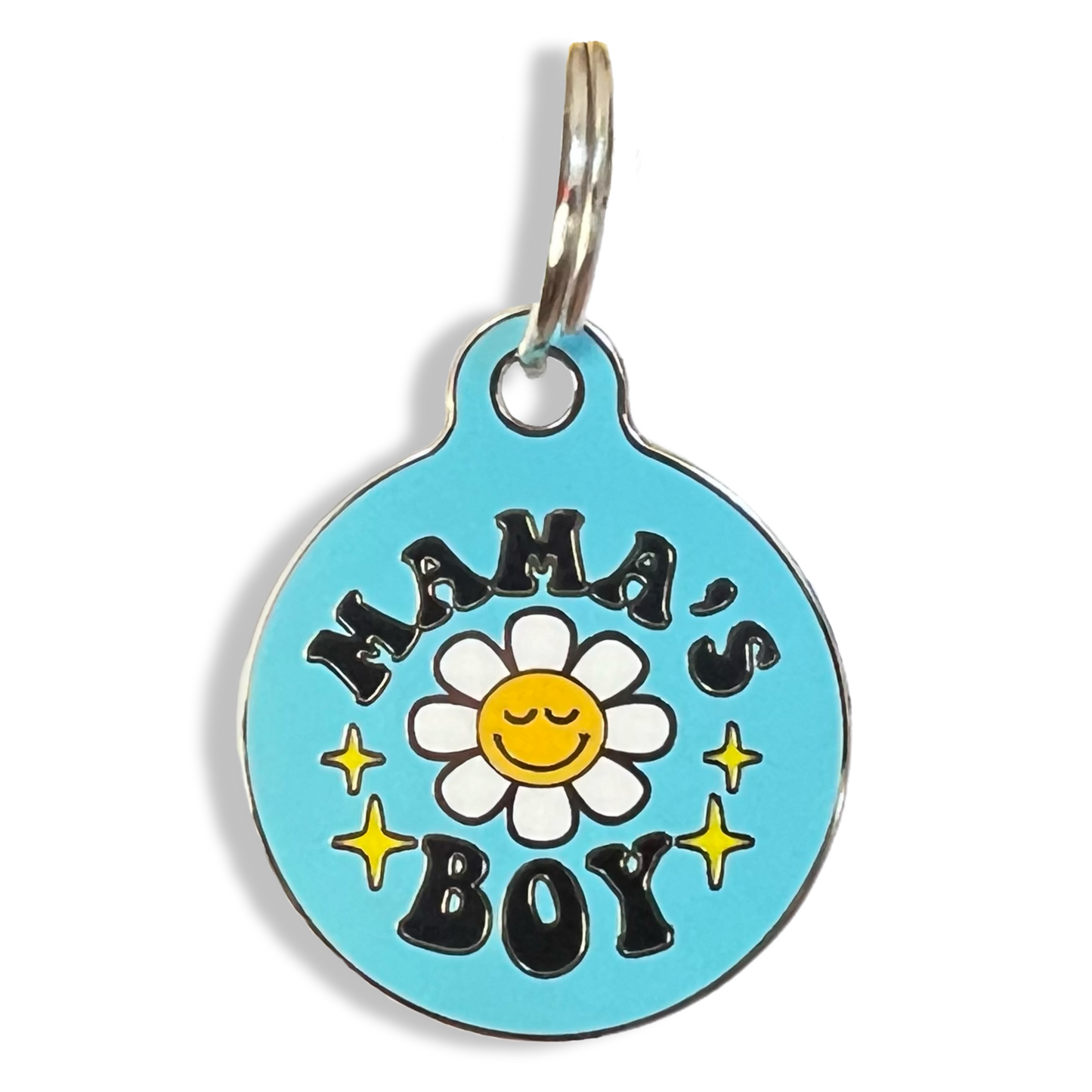 A charming dog id tag inscribed with "Mama's Boy," symbolizing the affectionate relationship between a dog and its mother.