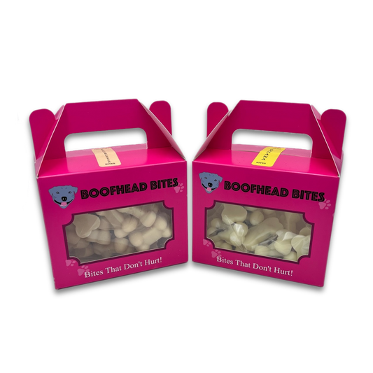 Two boxes of safe banana and strawberry yoghurt dog treats, designed to be gentle on pets while providing a tasty and enjoyable snack.
