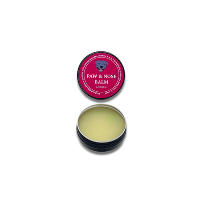 A tin of paw and nose balm featuring a pink and black design, showcasing a stylish and modern appearance.